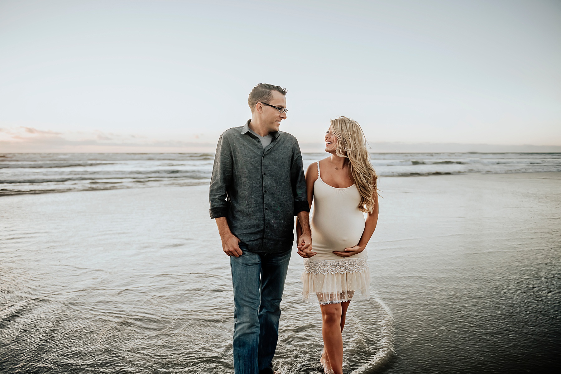 maternity pregnancy pictures on beach couple holding hands walking