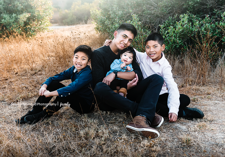 san elijo family photographer family photos family portrait session 4 siblings posing in grass field