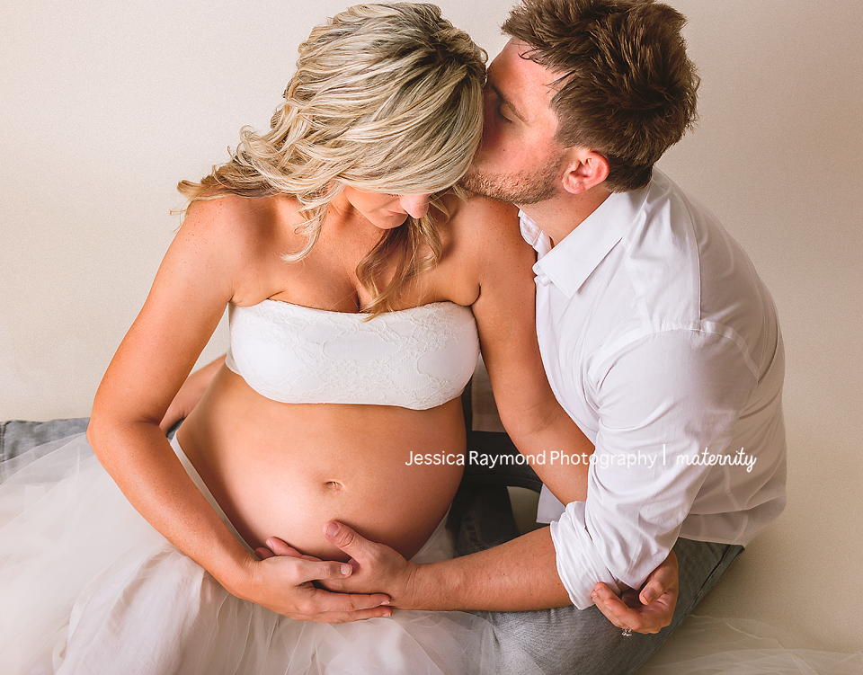 maternity photography in studio maternity session san diego california maternity pose with spouse sitting on floor