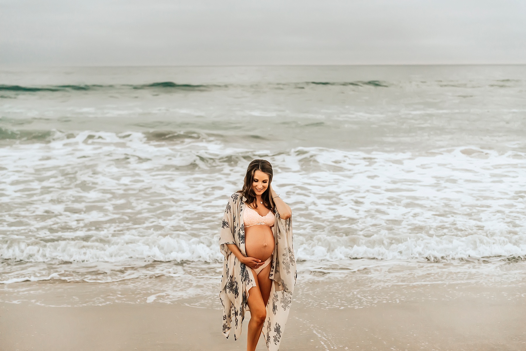 beach maternity pictures carlsbad mom walking in water