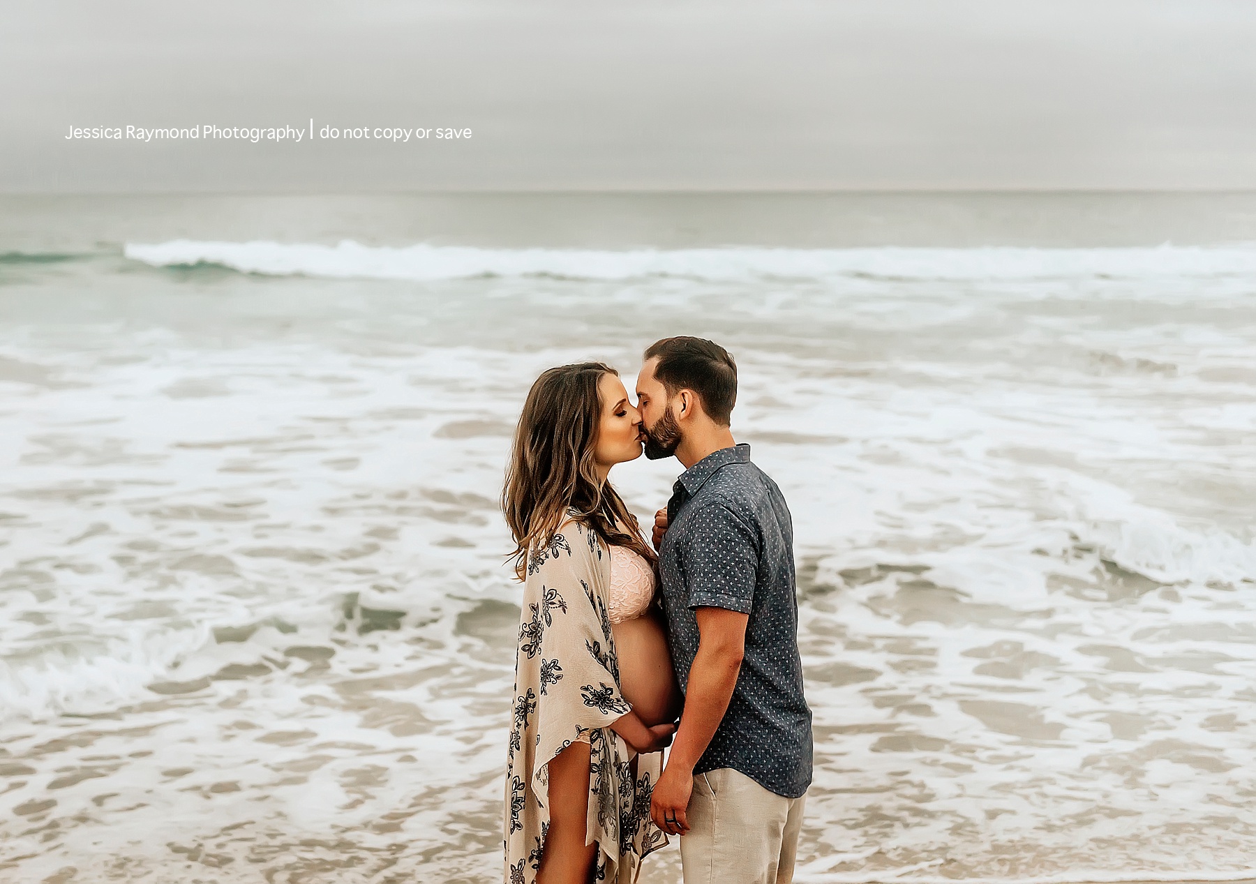 beach maternity pictures carlsbad couple kissing