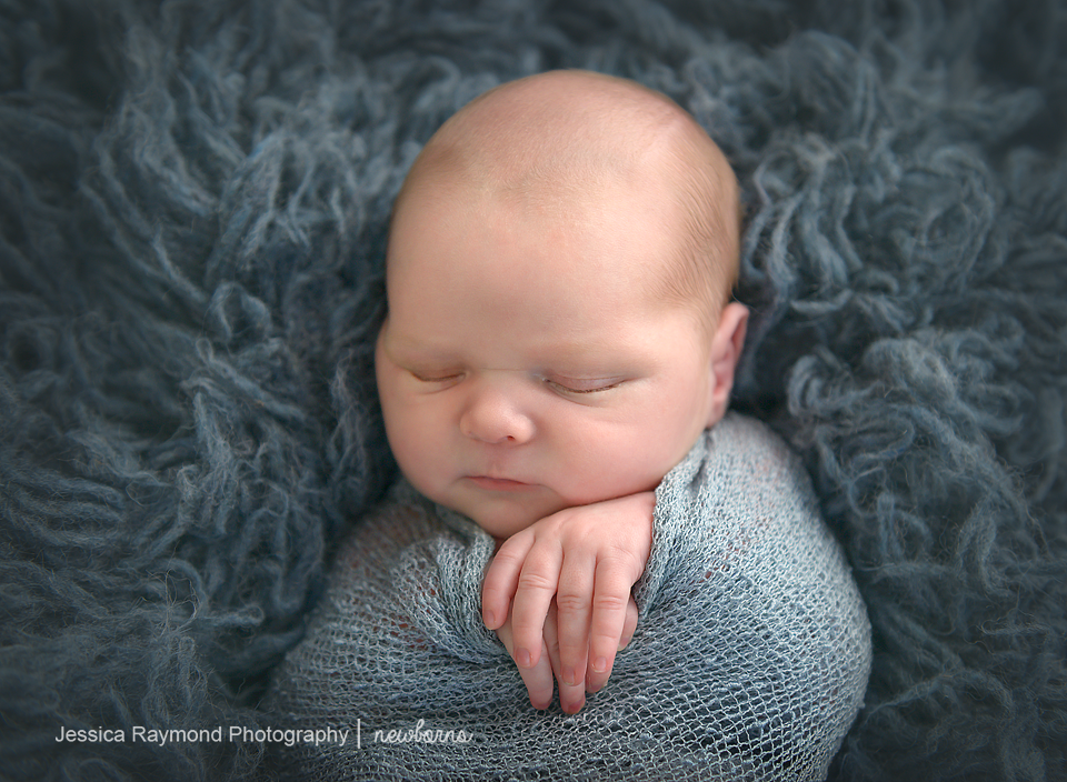 Newborn Photographer in San Diego newborn pictures baby wrapped in blue 