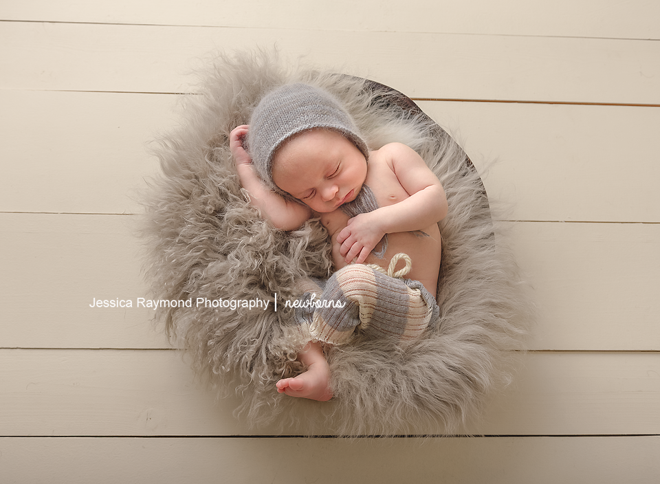 newborn photography studio session carlsbad california baby portraits baby boy in grey basket wearing grey beanie