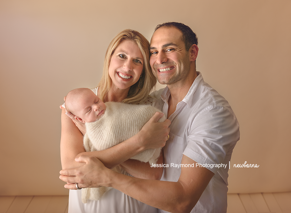 newborn photography studio session carlsbad california baby portraits parents holding baby boy